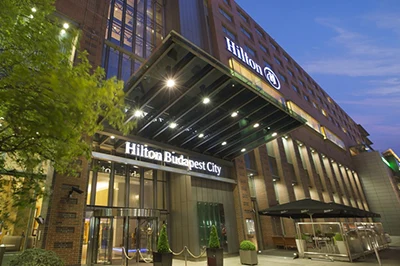 entrance and facade of the hotel with Hilton written in blue