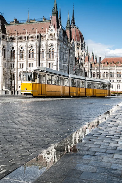Historical tram passing by parliament building