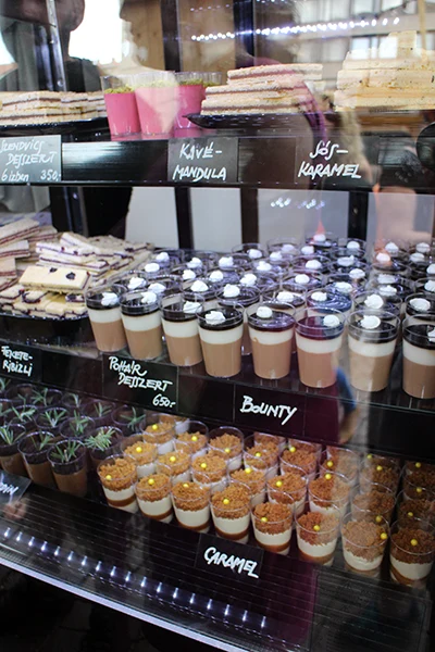 a range of shot glass desserts in  glass case
