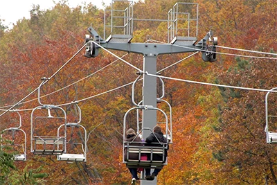 chairlift up János-hegy (Buda Hills) with view of the rusty coloured foligae in the valley