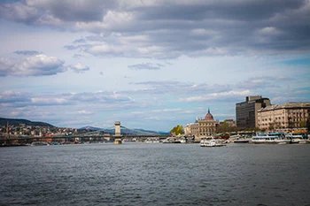 the Chain Bridge, the cupola of the Parliament and the hotels in Pest as seen from the deck of a cruise boat on the Danube on budapest cruise with lunch