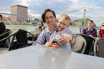 Me with our 6-yrs old sun on the upper deck of the cruise ship on a cloudy afternoon in March on budapest cruise with lunch