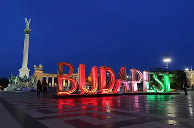 text installation "Budapest" lighted up in the national tricolor: red, white and green in front of the Millennium Monument at Heroes' Square.