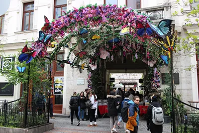 the entrance to Gozsdu Easter Market decorated with spring flowers and butterfly mockups