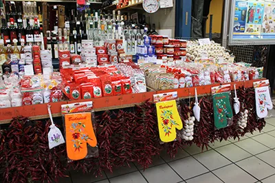 strings of red paprika, paprika powder, paprika paste, wines and other local specilaties arranged nicely in a sellers' booth