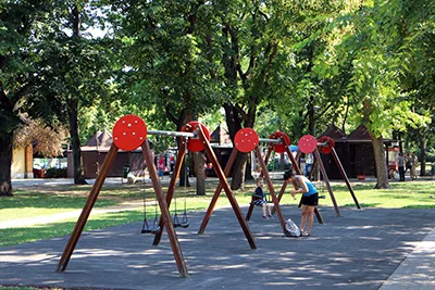 3 wooden swings at a playground in City park