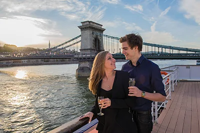 a romantic couple on a cruise boat near the Chain Bridge