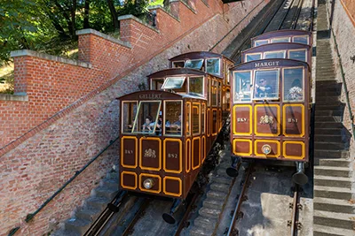 people travelling on the Funicular in Budapest, the photo shows 3 cars riding down and 3 cars going up