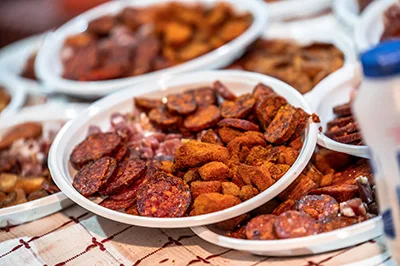 slices of Hungarian salami and pork crackle on plates