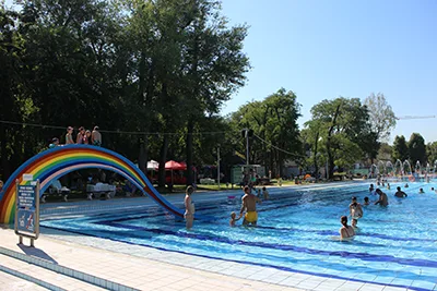 a kids' pool and a rainbow colored small slide at the Palatinus bath in Budapest