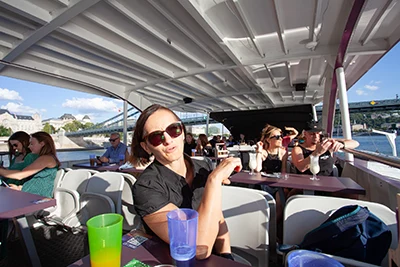 Me seating at a table on the upper deck of the Wiking cruise boat