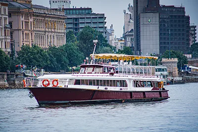 The white and purple, two tier cruise ship of Silver Line on the Danube during the day