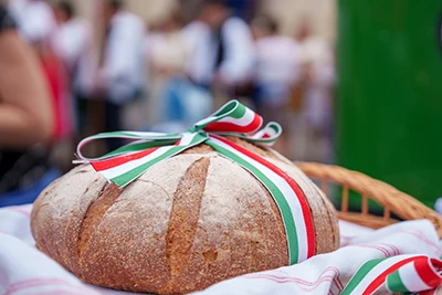 a round loaf of bread tied with a ribbon in the national tricolor of Hungary
