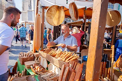 A folk artist offering his carved wooden utensils