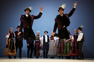 Hungarian folk dance performed by a group of men and women on a theatre stage