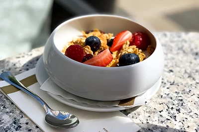 a bowl of granola with fresh fruits