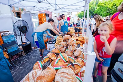 Hungary's bread at a bakery booth - half kg loaves adorned with a ribbon in the national tricolor