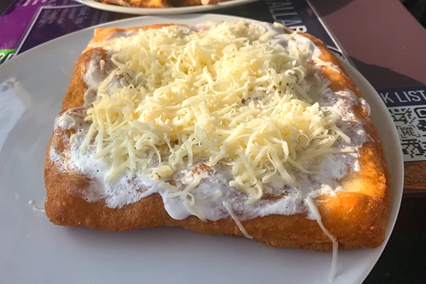 square shape langos with sour cream and cheese topping