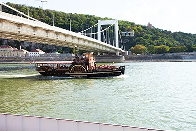 the historic steam boat, Kisfaludy gliding on the Danube at Elizabeth Bridge