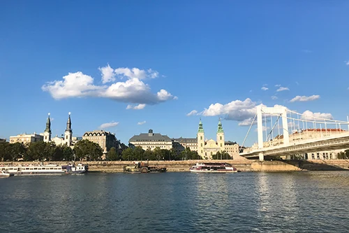 View of Inner City Parish Church and the Lutheran Church on the Danube Promenade, from the deck of the sightseeing boat