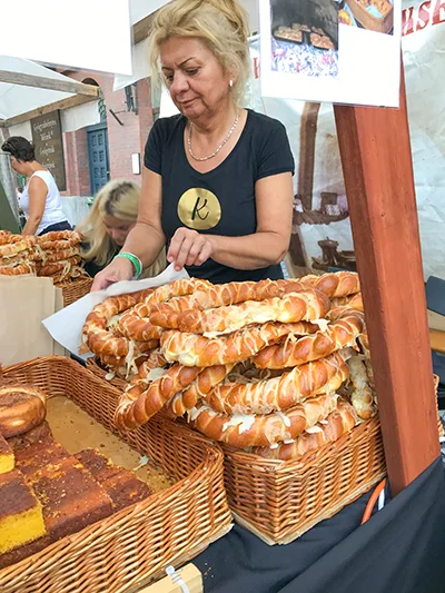 pretzel and other pastries sold by a middle aged woman vendor