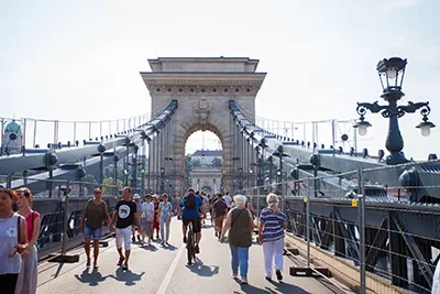 people walking on the Chain bridge on a festival