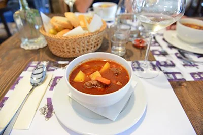 a bowl of goulash on a table