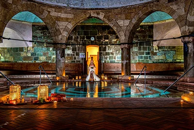 the arcaded hexagonal pool in the Turkish Rudas bath, some candles are lighted for Christmas