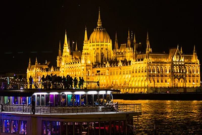 people partying on the upper deck of a tour boat in Budapest at night