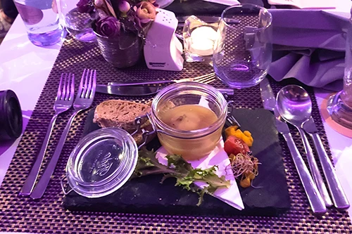 foie gras in its fat served in a jar with slices of bread