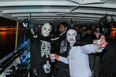 young party people dressed in Halloween costume on a boat party