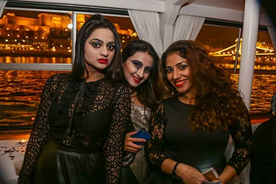 3 young ladies dressed elegantly and wearing party make up on a cruise ship