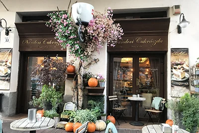 Pumpkins and other fall decoration at the entrance of Nádori Cake Shop in Budapest
