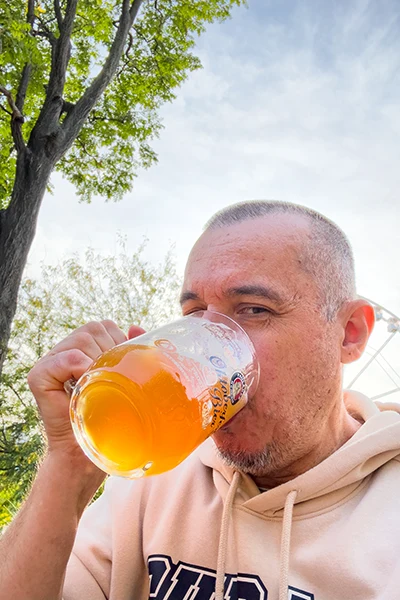 middle-aged men drinking a mug of unfiltered wheat beer