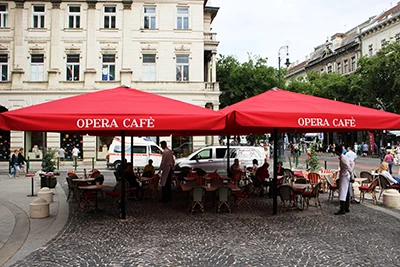 the Opera cafe's terrace with red tents above the tables