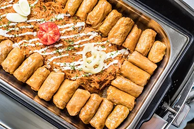 rolls of stuffed cabbage in a stainless steel warming container