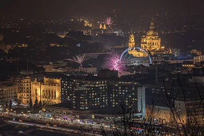 fireworks on NYE in downtown Budapest: St. Stephen's Basilica and teh EY are visible