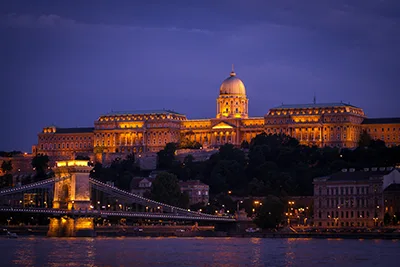 The lit up Buda Castle and part of the Chain Bridge at the blue hour