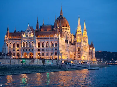 view of the illuminated Parliament from a cruise ship at the blue hour