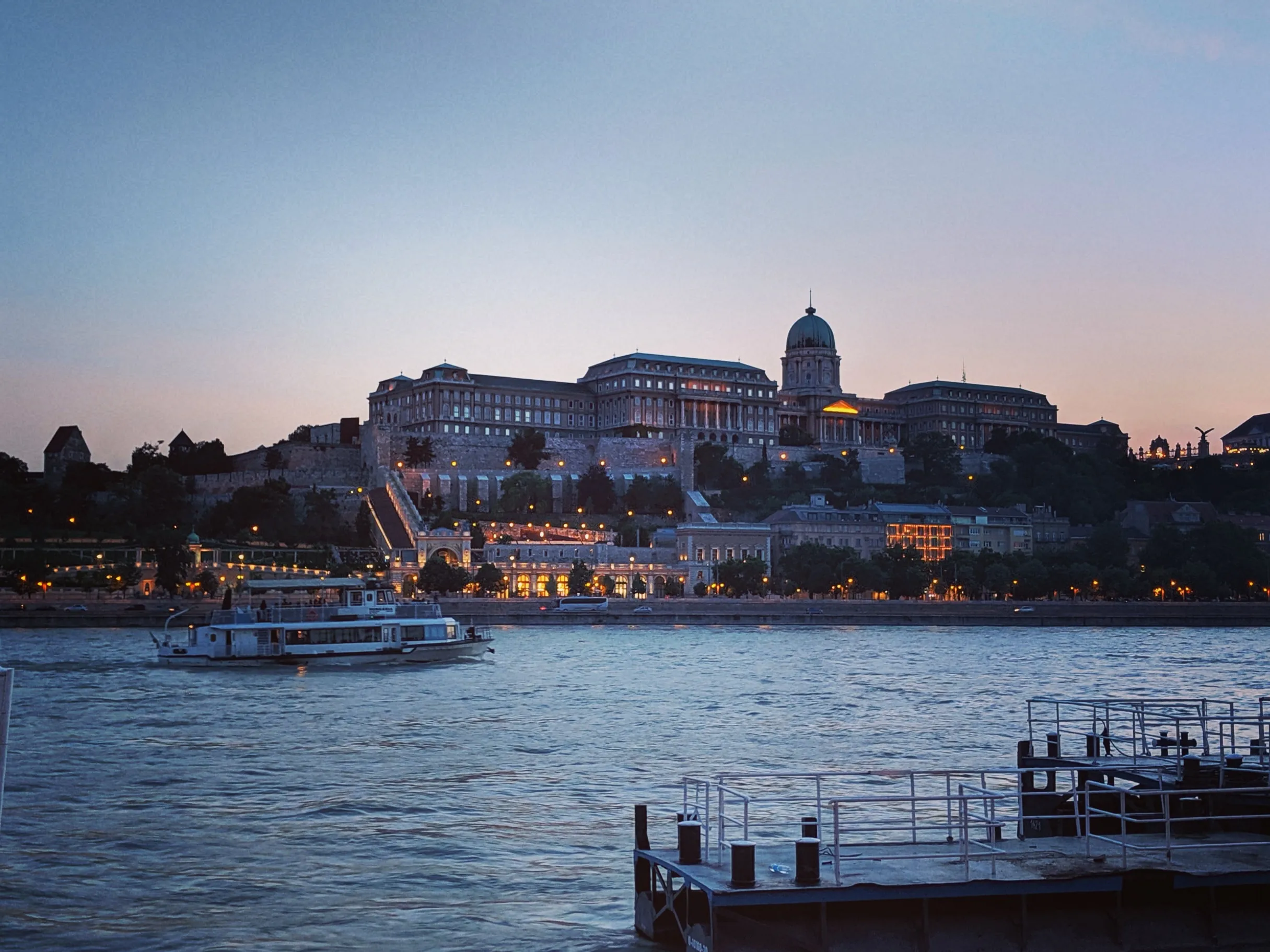 View of the Royal Palac ein Buda Castle at the start of the blue hour, photo was possibly taken from a boat on the Danube