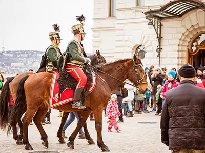 two mouted hussars galloping in Buda Castle