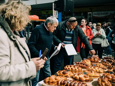 jury inspecting Easter cakes and breads at the festival in