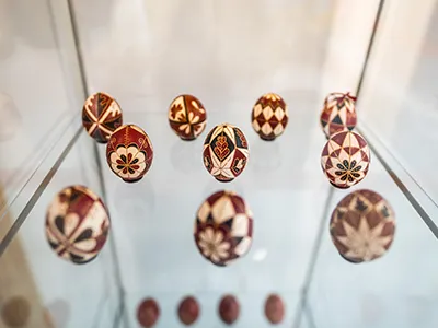10 hand-painted Hungarian Easter eggs displayed in a glass cabinet
