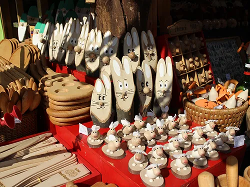 carved wooden bunnies and small sheep at the Easter fair