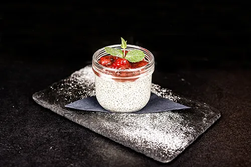 Chia pudding with strawberry and mint served in a glass