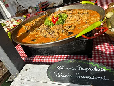 cat fish paprikash in a big pot, possibly on a food festival