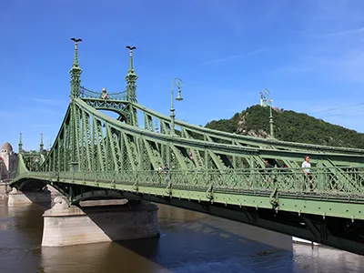 the green Liberty Bridge on a sunny early April day